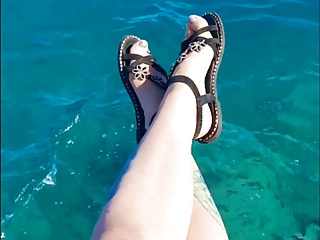 Dominatrix excites you with her feet on the sea