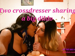 Two crossdresser sharing a big dildo
