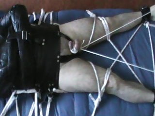 Straitjacketed slave&#039;s cock is tied