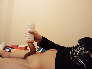 The young man tries the new toy in the bed by massaging it by hand and records it as a video.