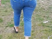 Woman wets jeans in park 