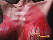 Pamela's big fake round tits are showered with hot wax
