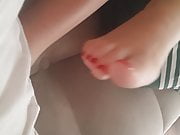 Her sexy dangling feet, pedicured red toes 