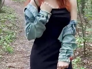 Sexy redheaded pussy walks through the woods almost naked