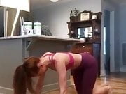 Red haired Danielle Moinet stretching at home