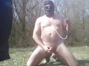 Slave naked in the woods jerking cock