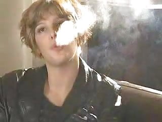 Short haired redhead smokes