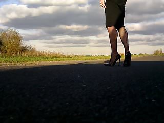 Walking in black patent hells fishnets and black tight skirt
