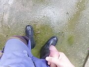 Worker shooting load on wellies after a rainy work day