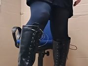 Crossdresser posing in boots and stockings. 