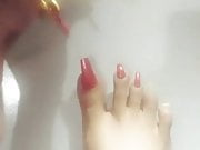 Kheora Seong paint her long toenails
