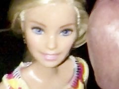 Rubbing cock over Barbie face. 